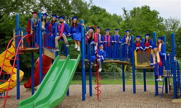 Seniors take pictures on the playground